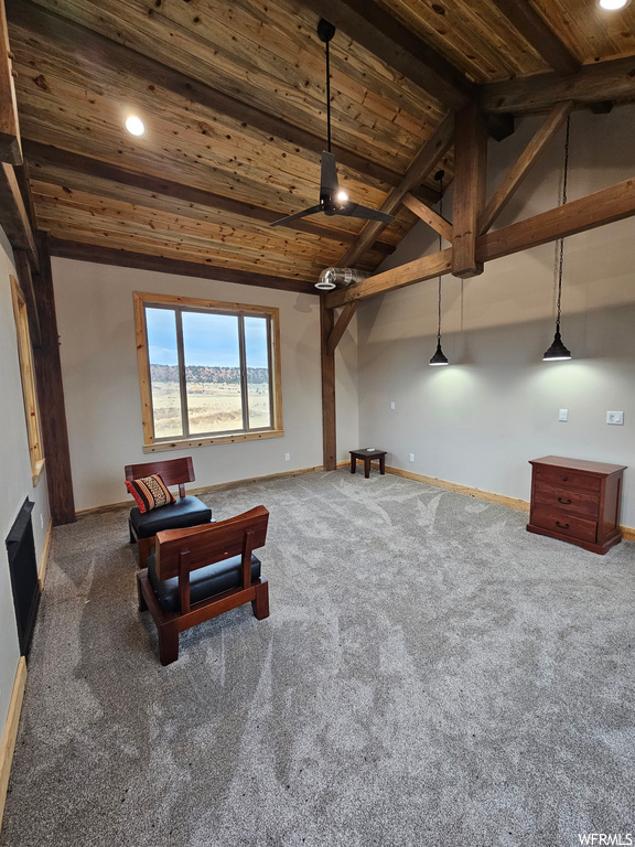 Living area with vaulted ceiling with beams, wood ceiling, and dark carpet