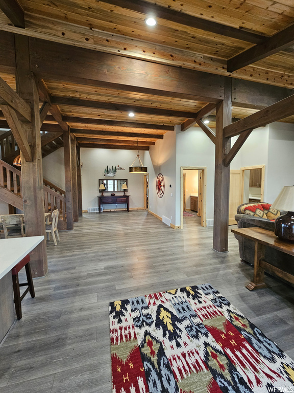 Interior space with wood-type flooring and beam ceiling