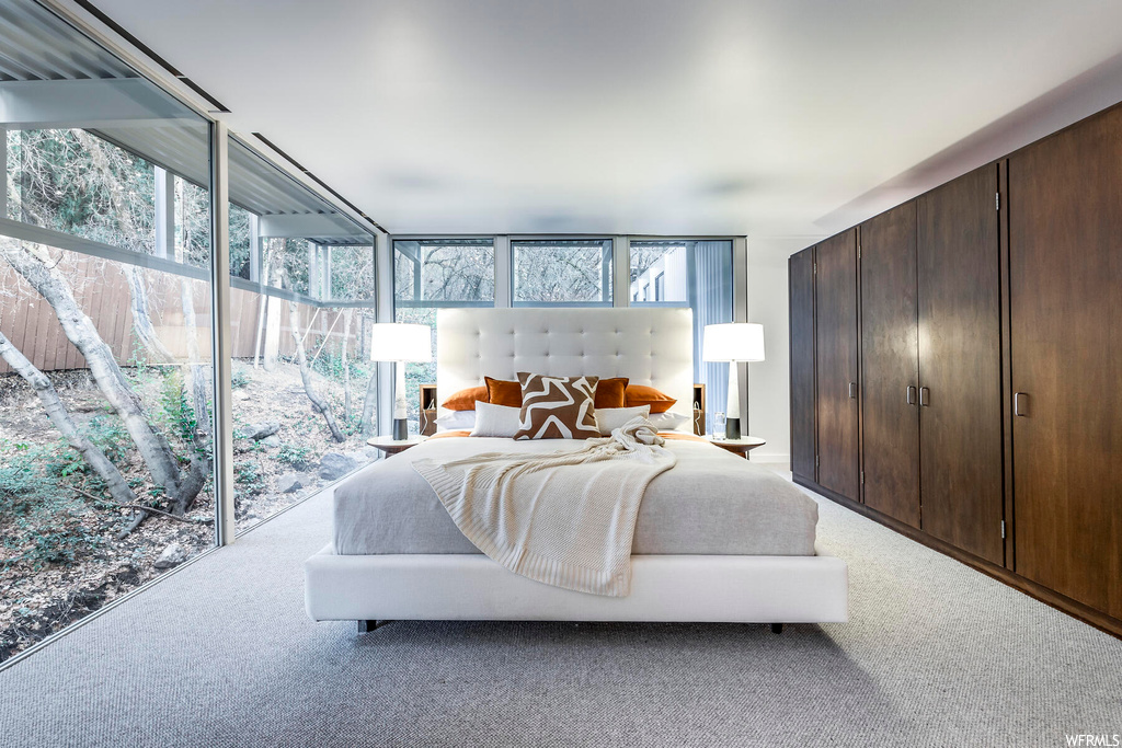 Bedroom with access to outside and light colored carpet