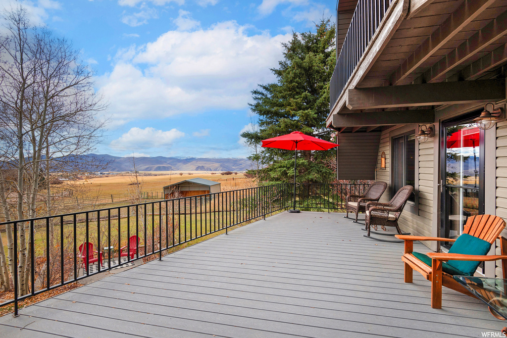 Wooden terrace with an outdoor structure and a mountain view
