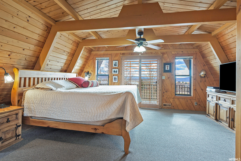 Carpeted bedroom with wooden ceiling, wood walls, lofted ceiling with beams, and access to exterior