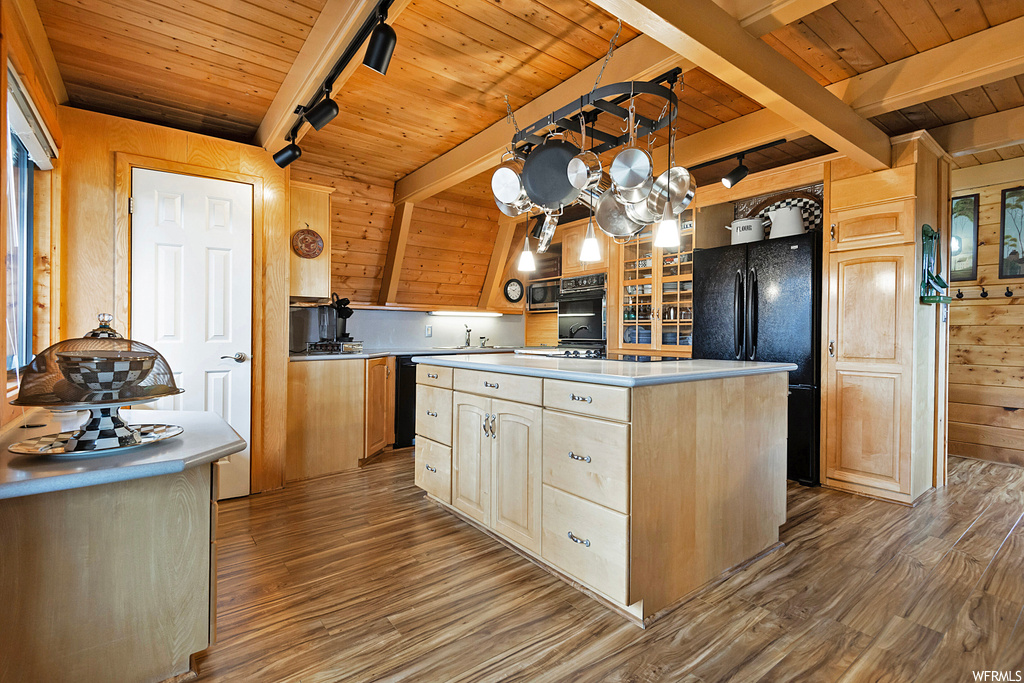 Kitchen with hardwood / wood-style flooring, wooden ceiling, a kitchen island with sink, beam ceiling, and wood walls