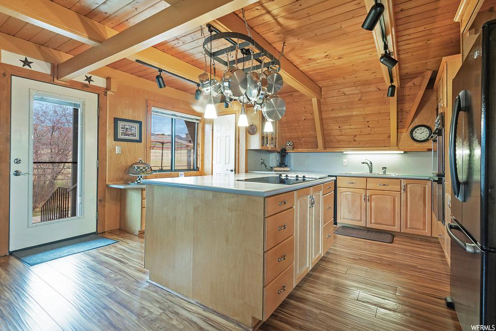 Kitchen featuring a center island, a wealth of natural light, and wood ceiling