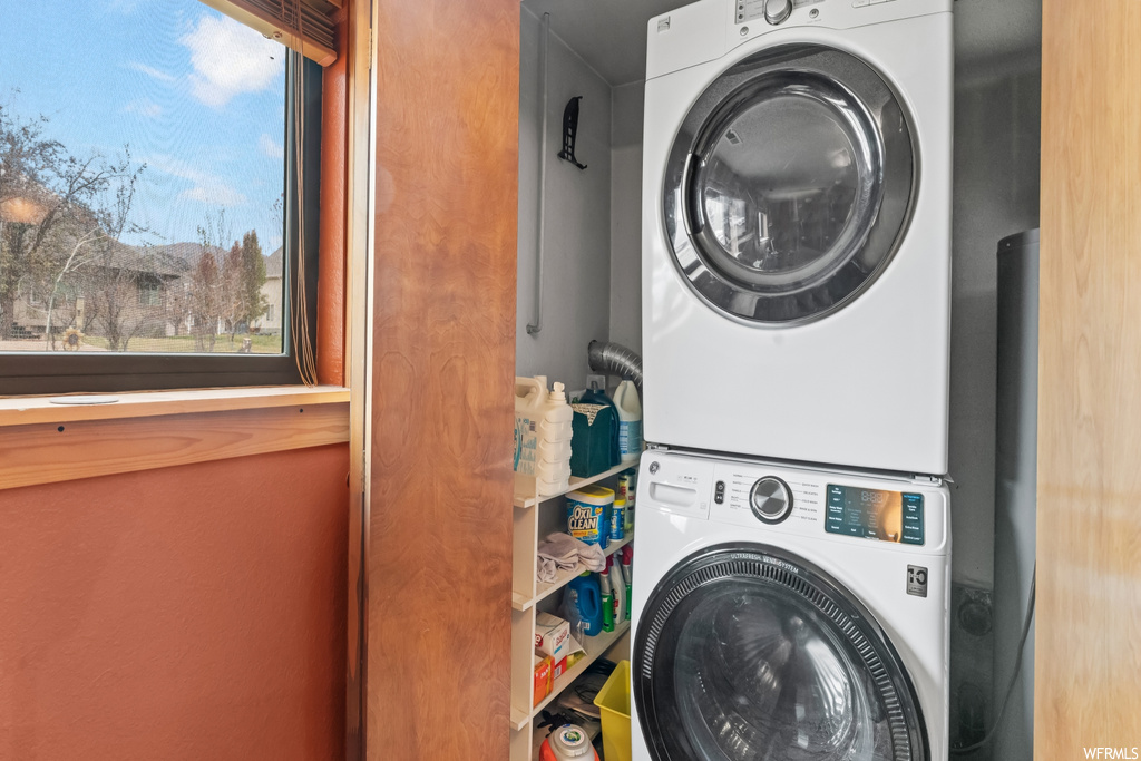 Washroom featuring stacked washer and clothes dryer