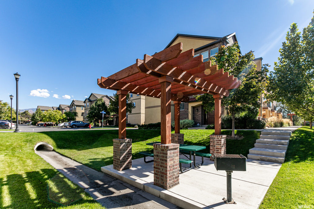 Surrounding community featuring a pergola and a yard