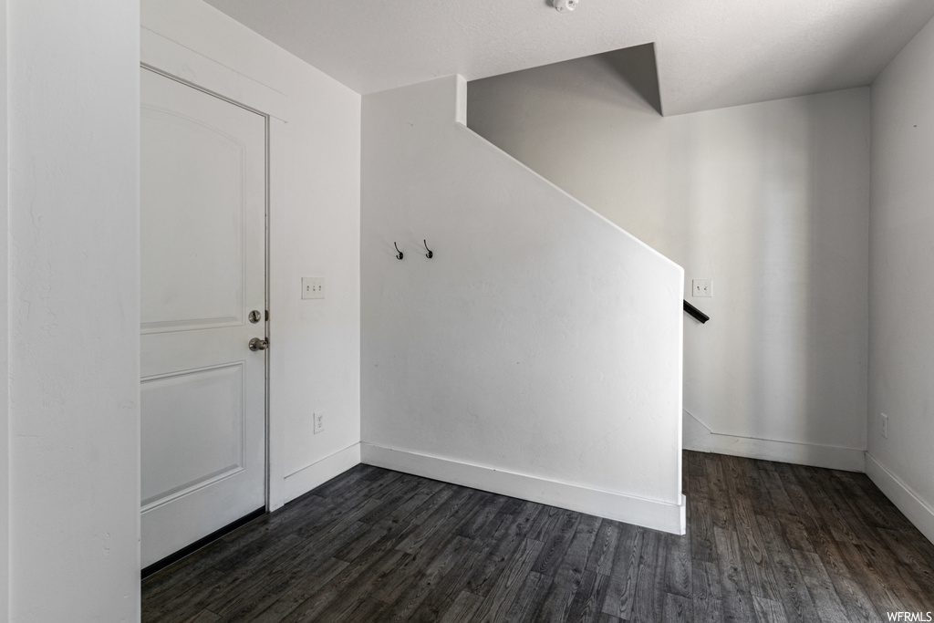 Entrance foyer with dark hardwood / wood-style flooring
