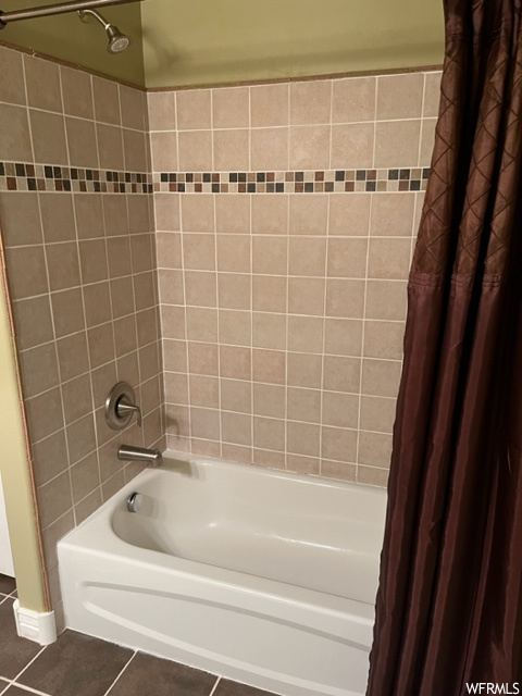 Bathroom featuring tile floors and shower / bath combo