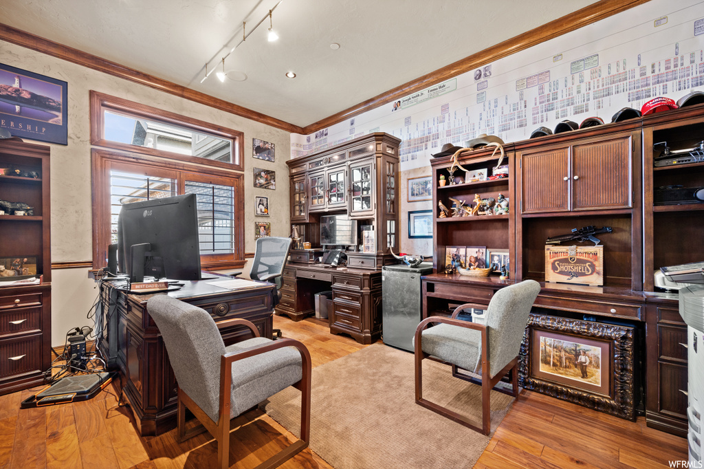 Office with track lighting, crown molding, and light hardwood / wood-style flooring