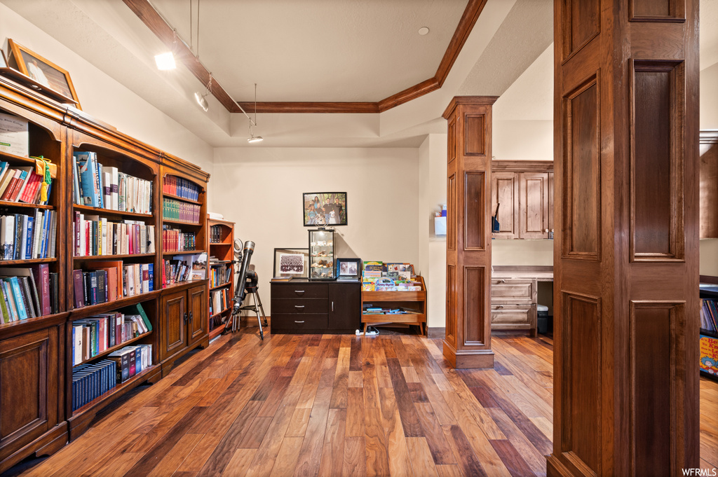 Office featuring dark hardwood / wood-style floors and crown molding