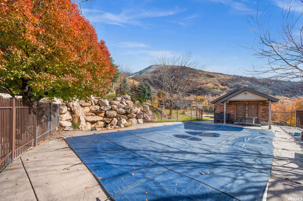View of pool with a patio and a mountain view
