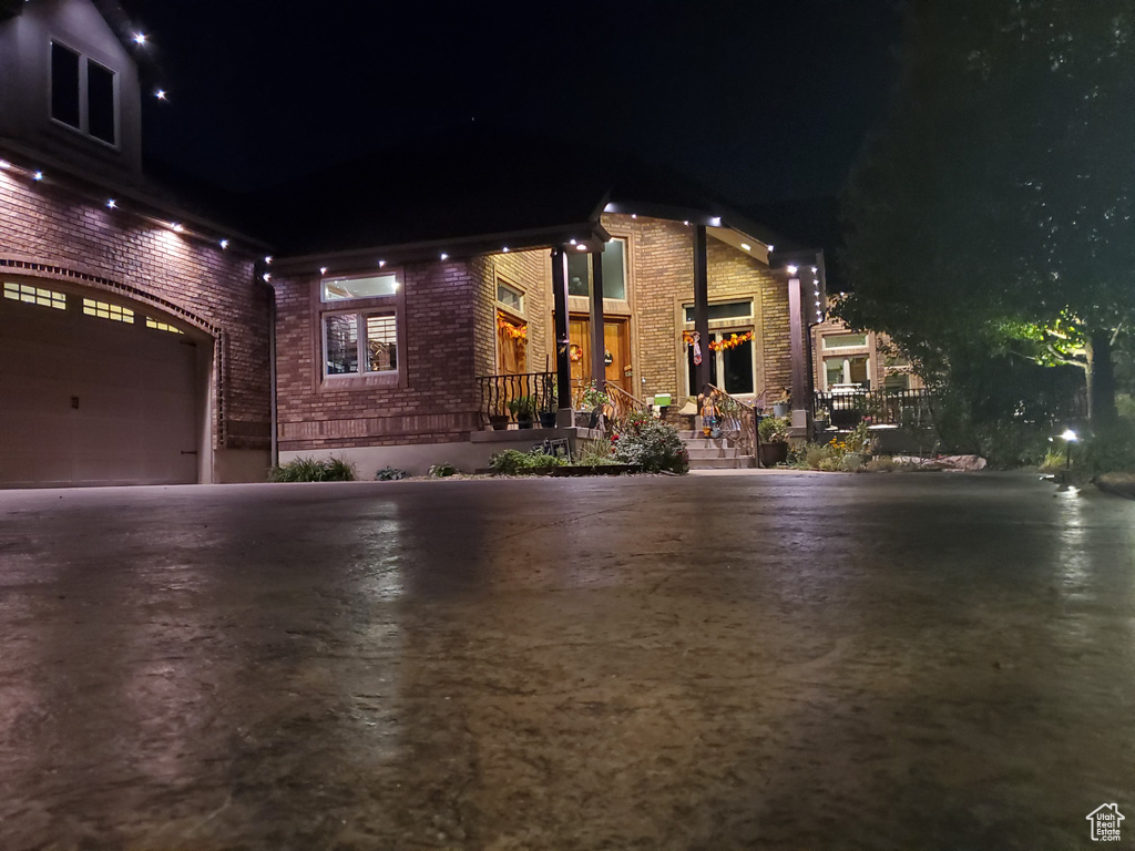Property exterior at night featuring a garage