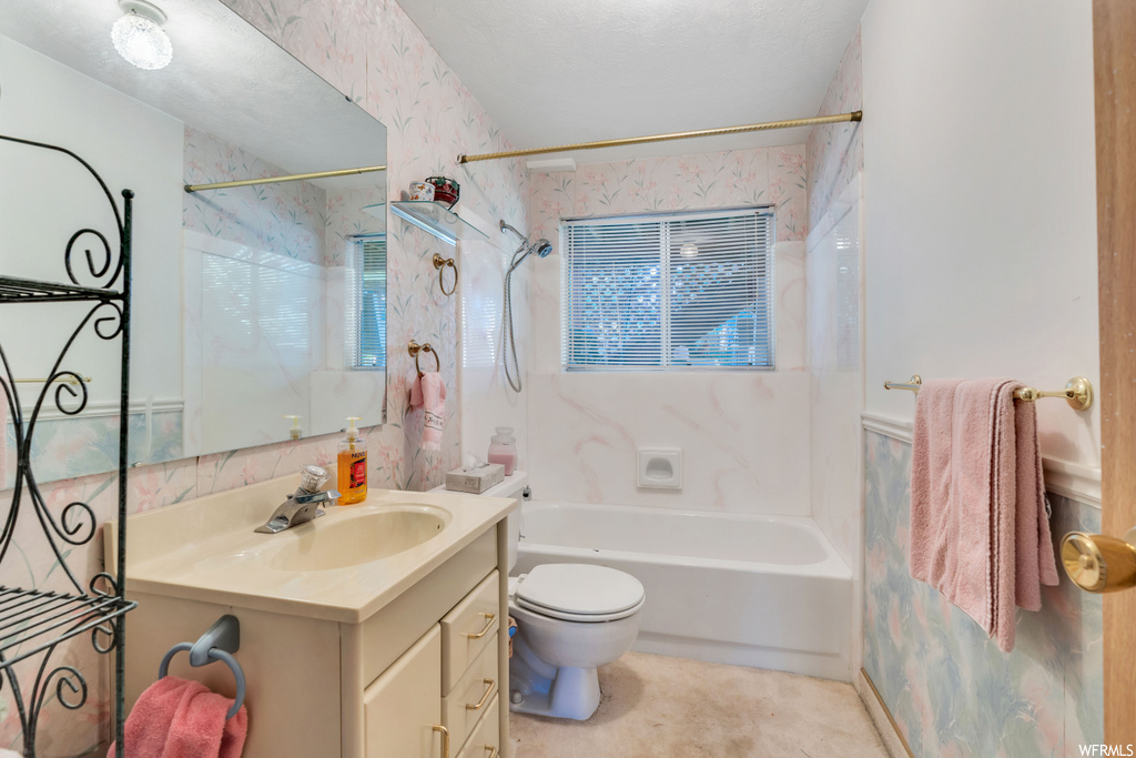 Full bathroom featuring toilet, shower / washtub combination, and large vanity