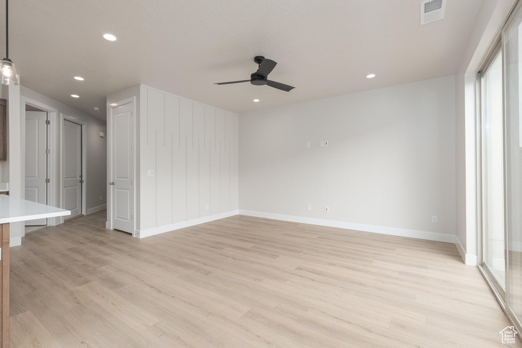 Unfurnished room featuring light wood-type flooring and ceiling fan