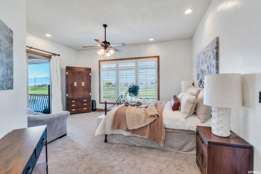 Carpeted bedroom with ceiling fan and access to exterior