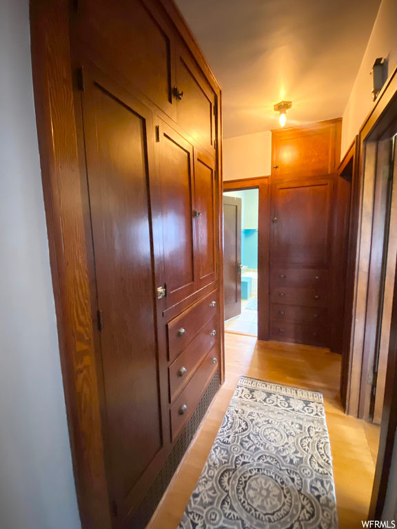 Corridor with light hardwood / wood-style floors