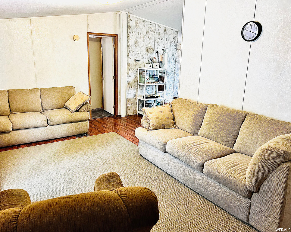 Living room featuring dark hardwood / wood-style floors and vaulted ceiling