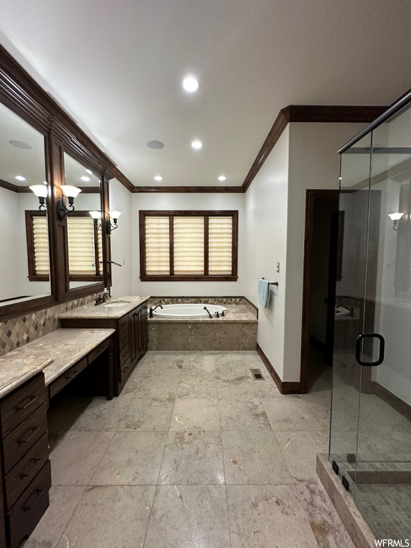 Bathroom with ornamental molding, tile flooring, and vanity