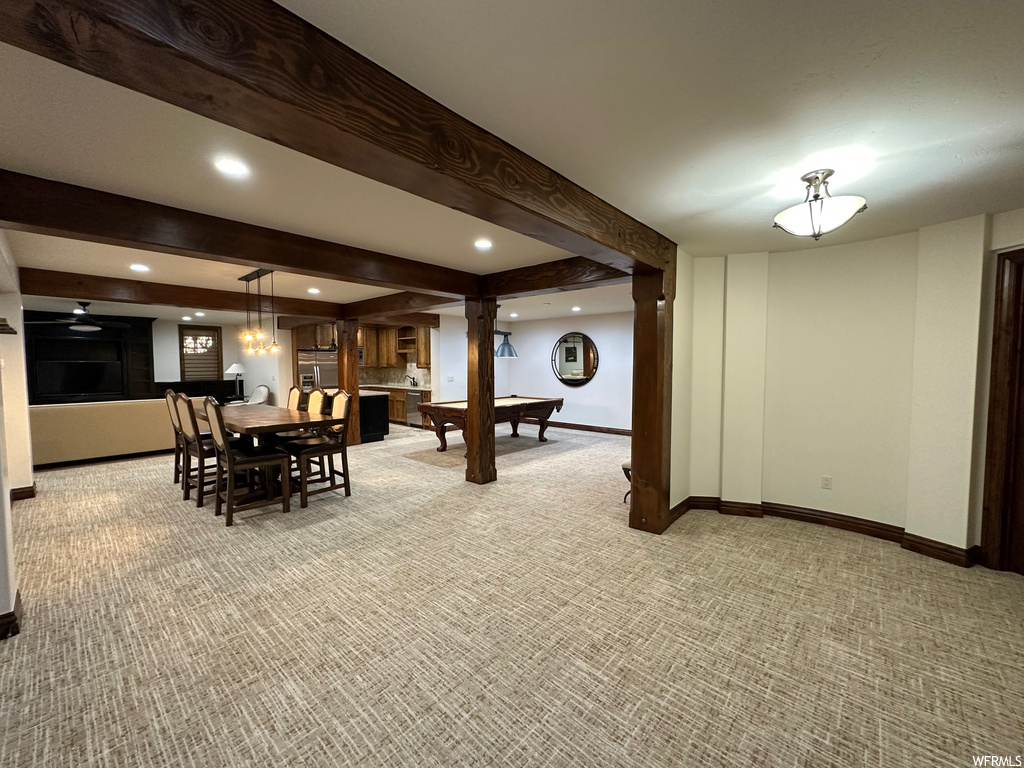 Dining area featuring light carpet and beam ceiling