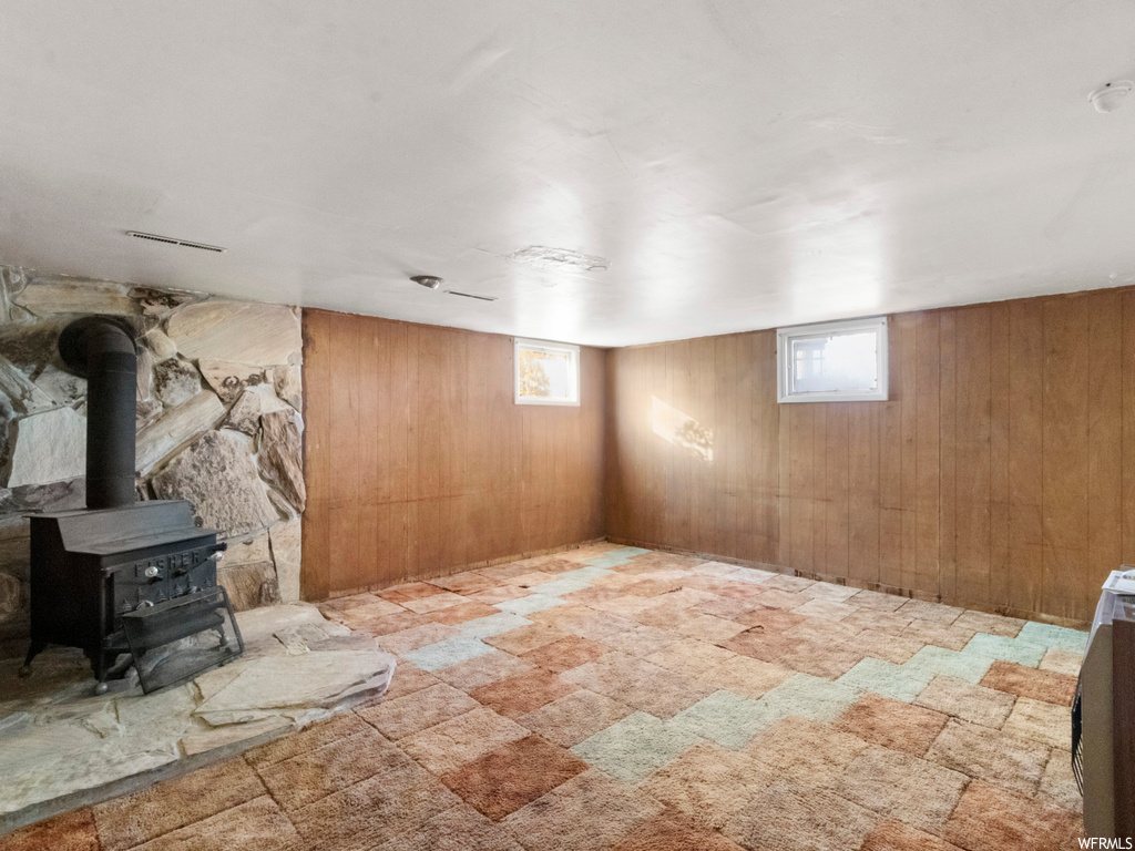 Basement with a wood stove and wooden walls