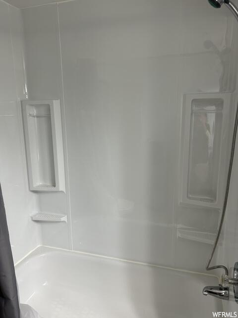 Bathroom featuring washtub / shower combination