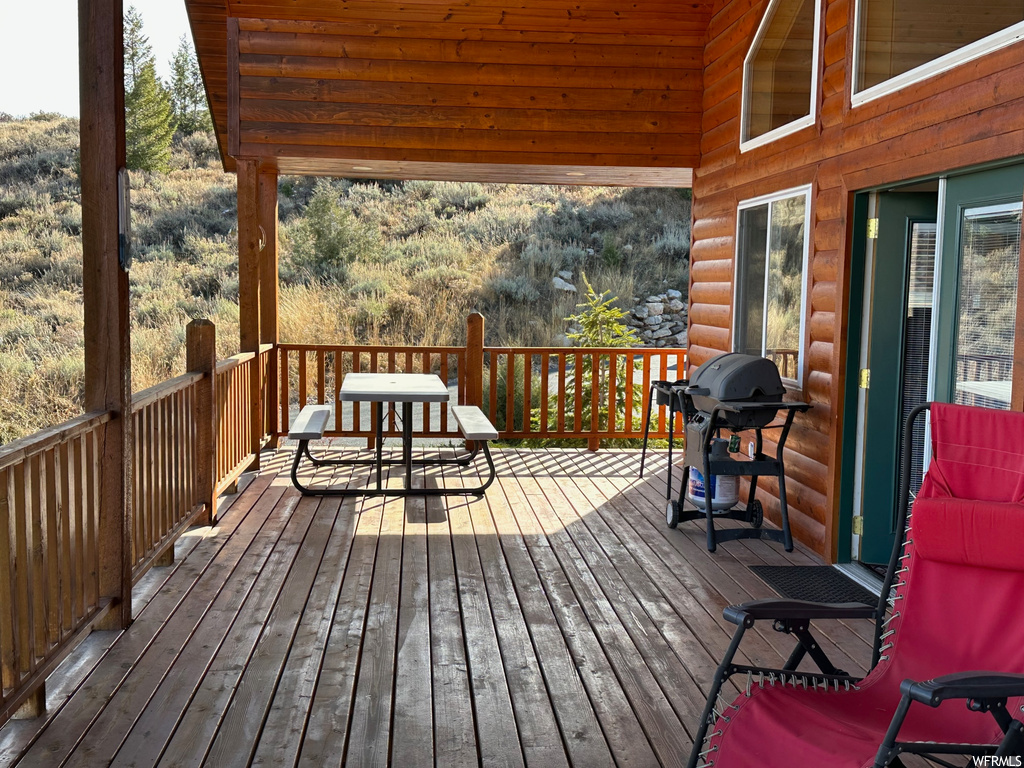 Wooden deck featuring area for grilling