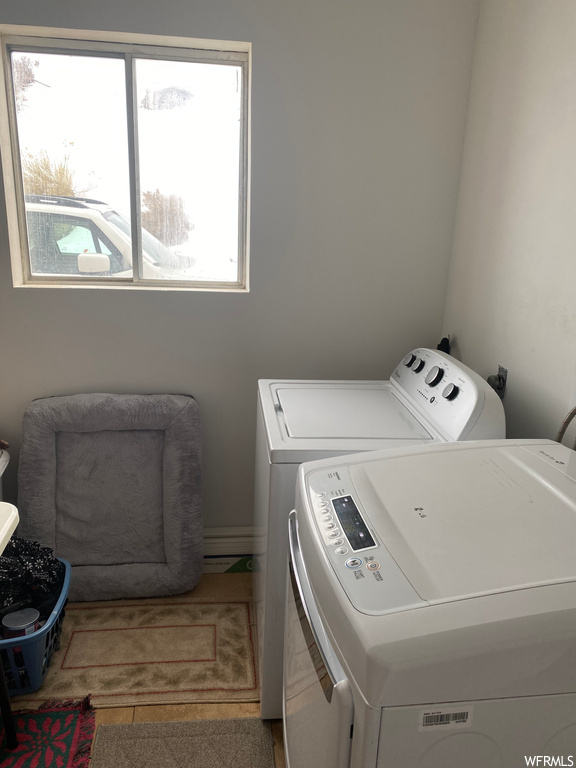 Laundry room featuring a wealth of natural light, electric dryer hookup, and washing machine and dryer