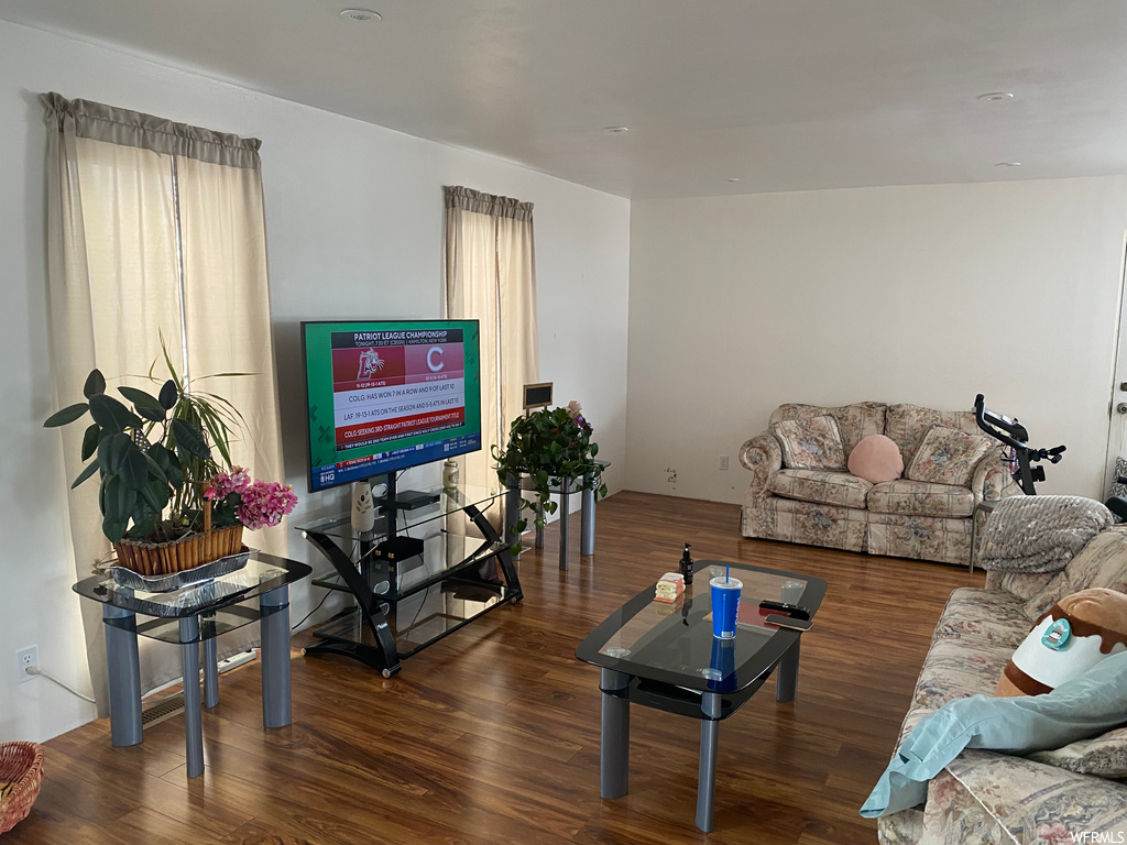 Living room with dark wood-type flooring