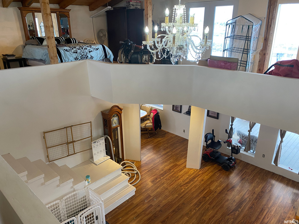 Interior space featuring a chandelier, plenty of natural light, and dark hardwood / wood-style flooring