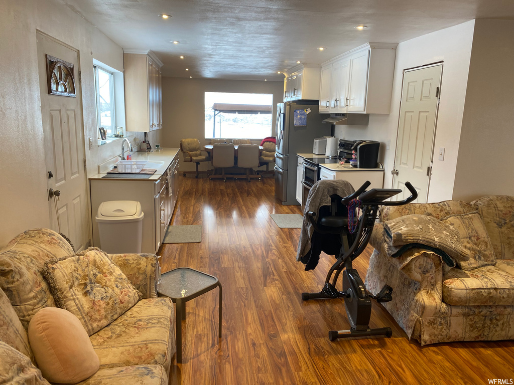 Living room featuring dark hardwood / wood-style floors and sink