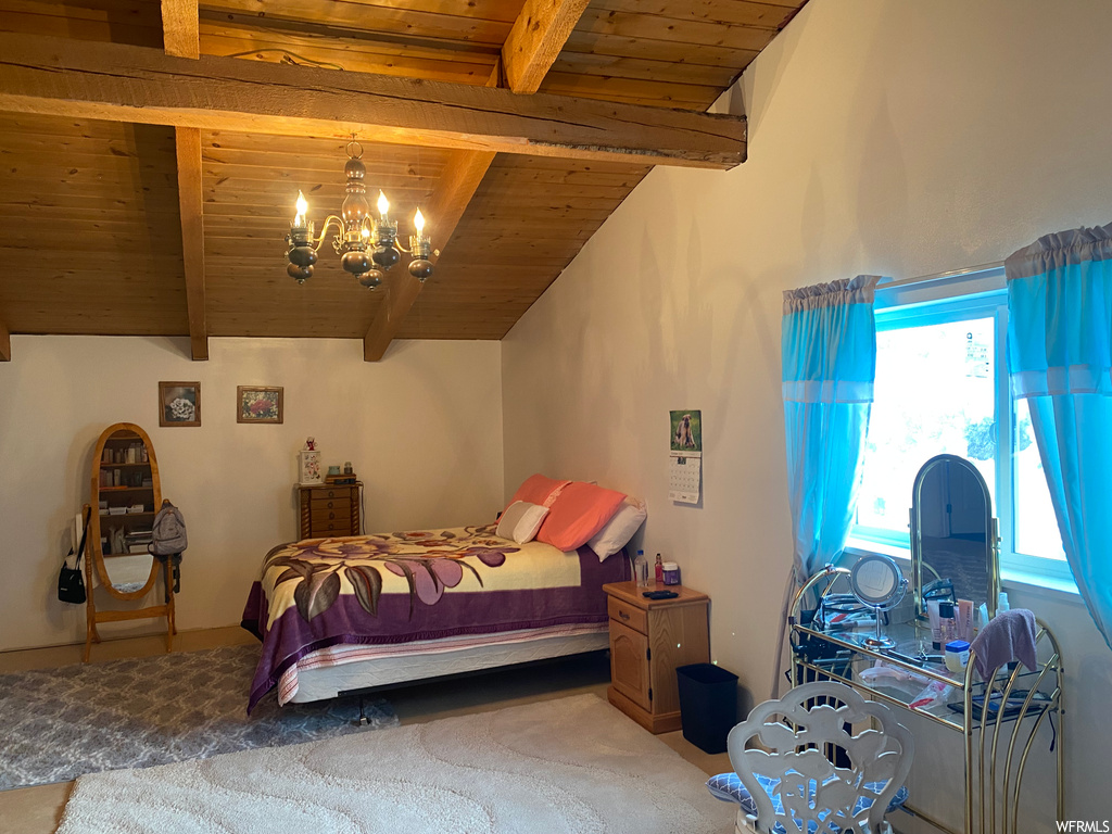 Carpeted bedroom featuring wood ceiling, beamed ceiling, and a notable chandelier