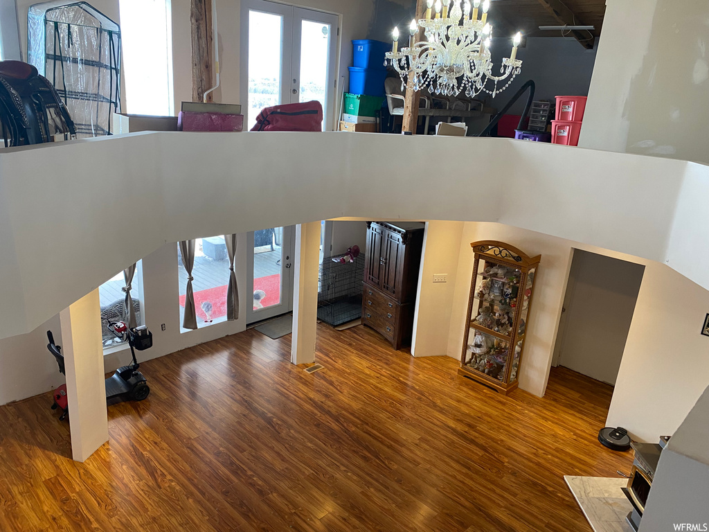 Living room with hardwood / wood-style floors and a notable chandelier