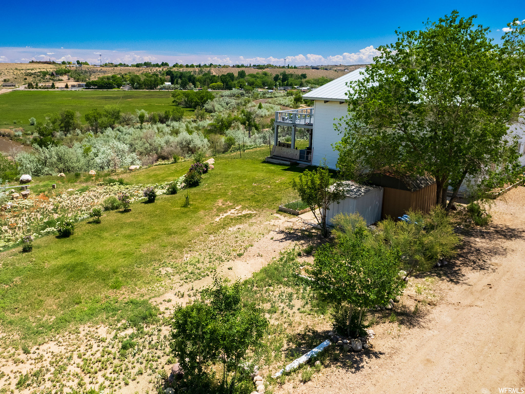 View of yard featuring a balcony and a rural view