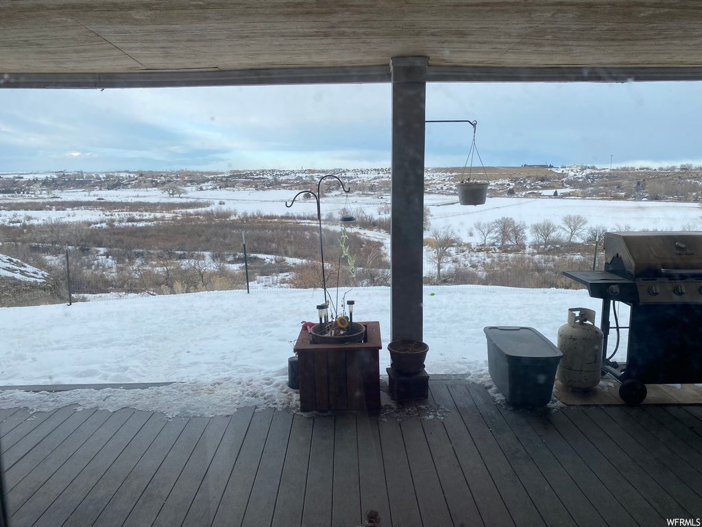 Snow covered deck featuring area for grilling