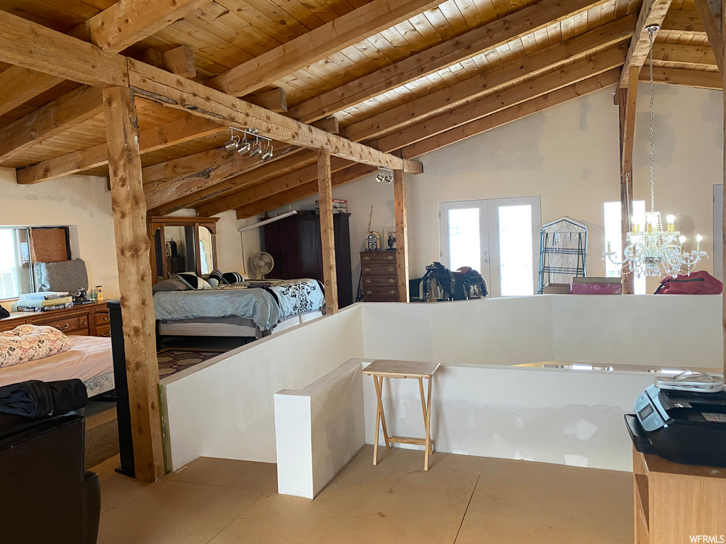 Bedroom featuring wood ceiling, french doors, an inviting chandelier, and vaulted ceiling