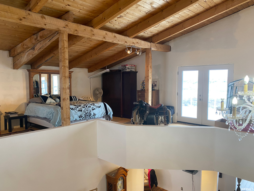 Bedroom featuring wood ceiling, access to exterior, lofted ceiling with beams, and french doors