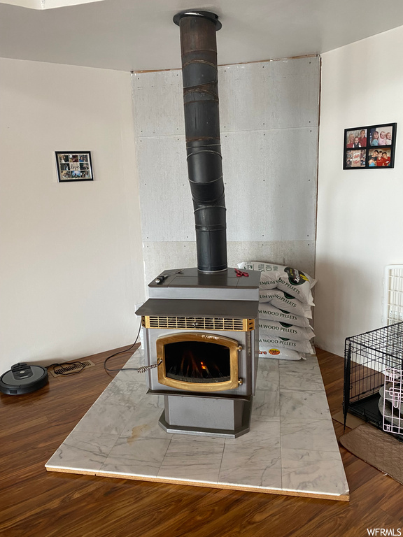 Details featuring light wood-type flooring and a wood stove