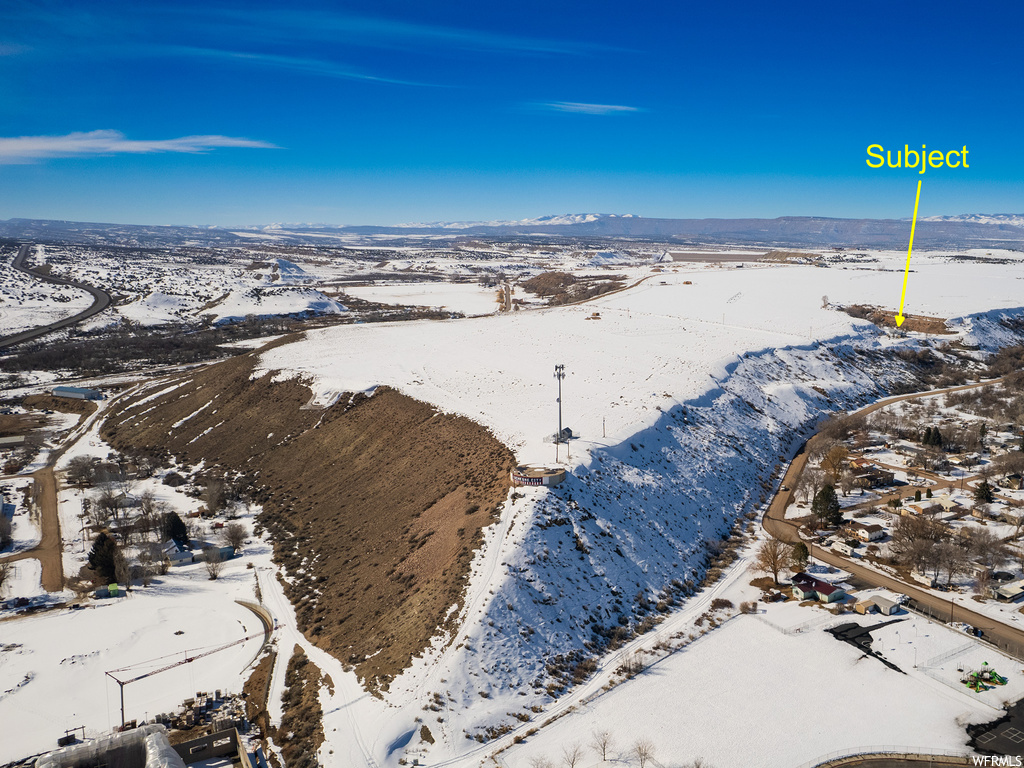 Snowy aerial view featuring a mountain view