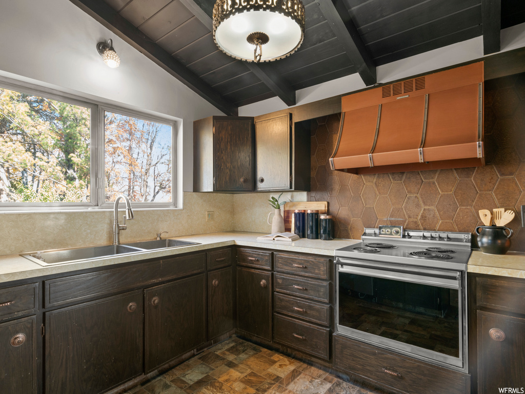 Kitchen featuring custom exhaust hood, tasteful backsplash, vaulted ceiling with beams, white range with electric stovetop, and wooden ceiling