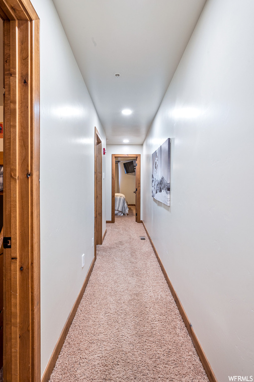 Hallway with light carpet