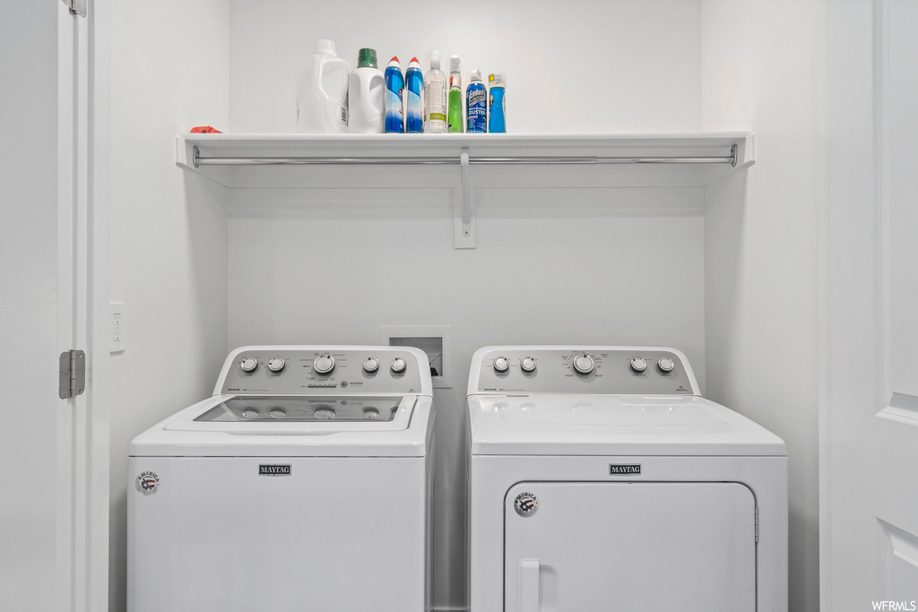 Washroom featuring washer hookup and washing machine and dryer