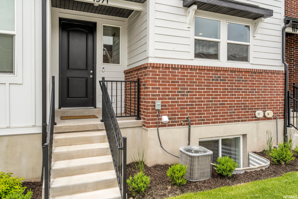 Entrance to property featuring central AC