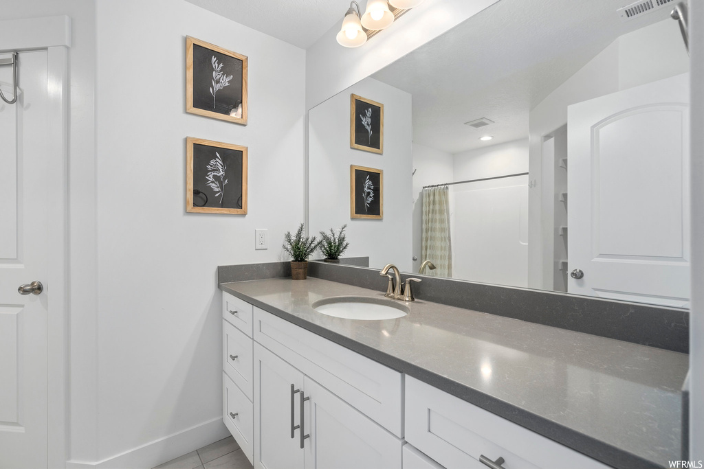 Bathroom featuring tile flooring and oversized vanity