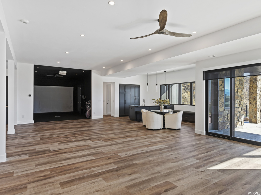 Interior space with sink, ceiling fan, and hardwood / wood-style flooring