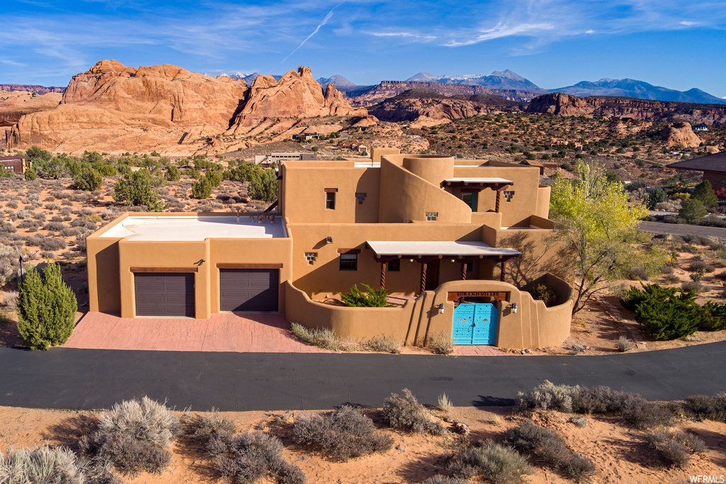 Pueblo-style home featuring a mountain view