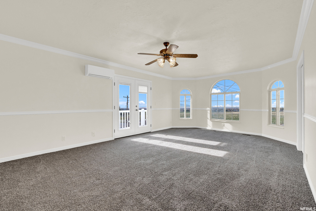 Unfurnished room with french doors, dark carpet, ceiling fan, and ornamental molding
