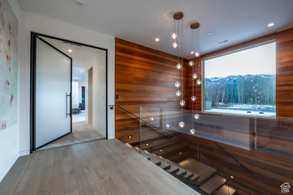 Interior space featuring wooden walls, a mountain view, and hardwood / wood-style floors