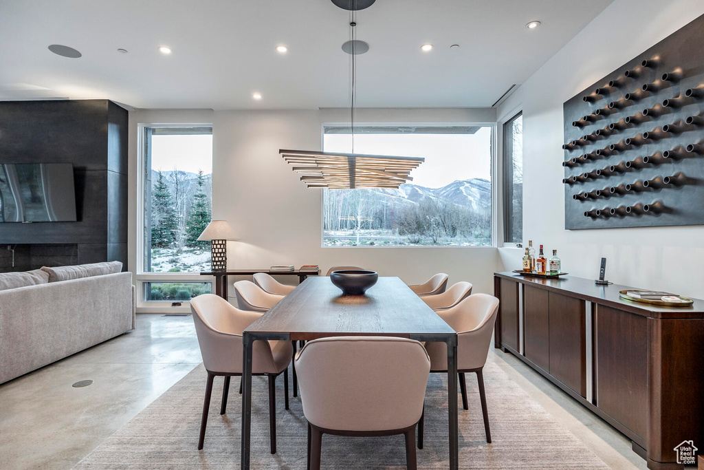 Dining area with a wealth of natural light, a mountain view, and a fireplace