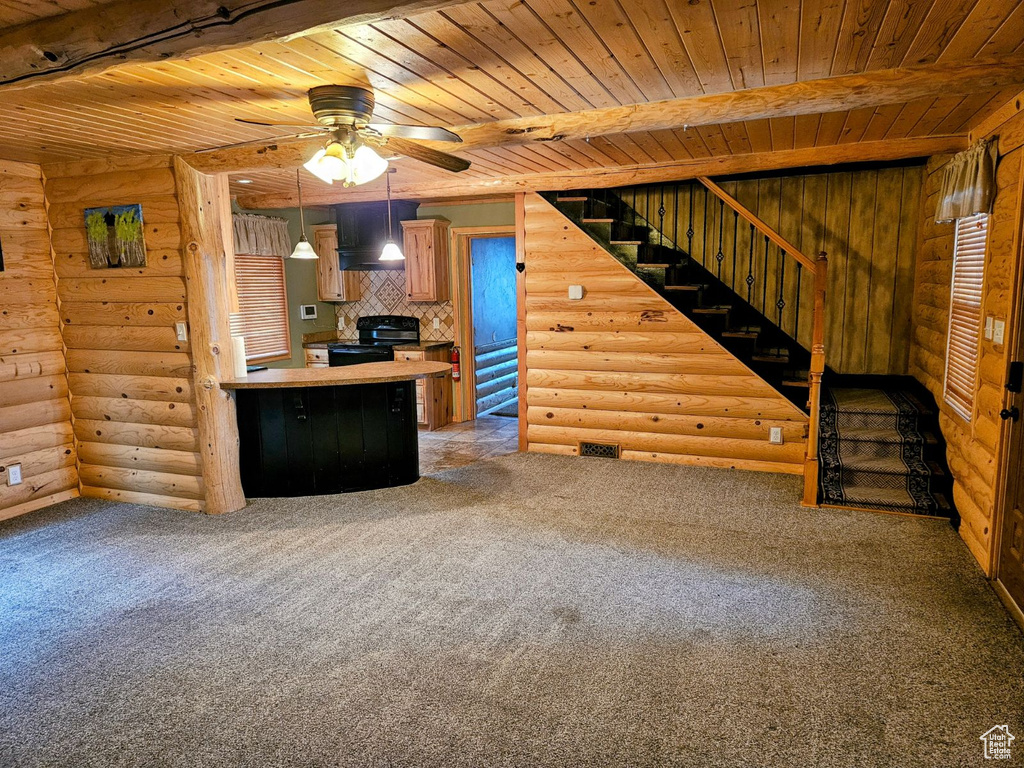 Interior space with wooden ceiling, pendant lighting, log walls, and carpet flooring