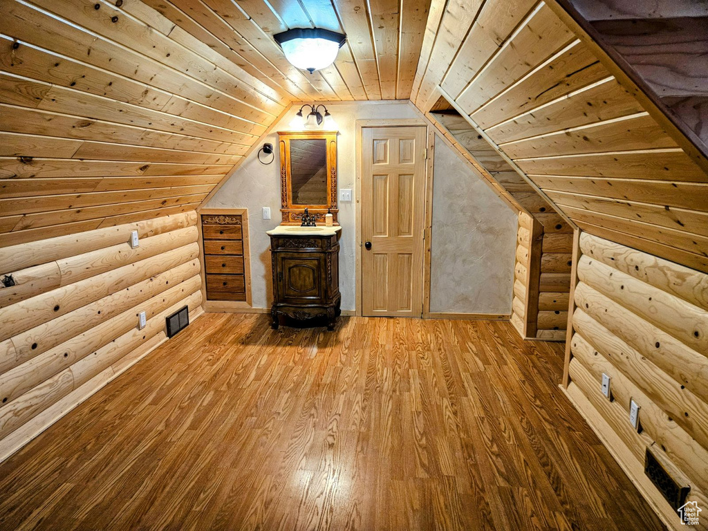 Bonus room with sink, lofted ceiling, light hardwood / wood-style floors, and wooden ceiling