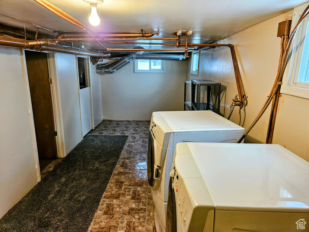 Laundry room with washer hookup, dark tile floors, and washer and dryer